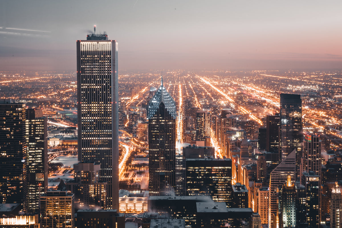 An elevated city view with high-rise buildings and illuminated streets